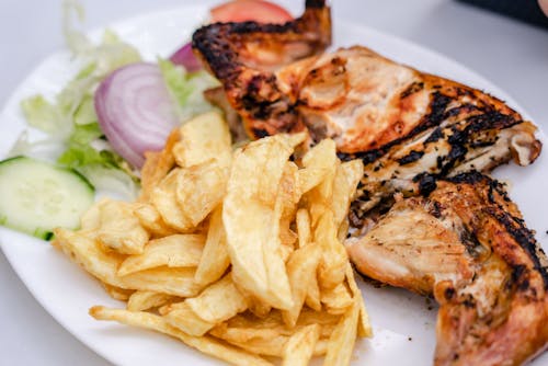 Photo of a Plate with Fries and Grilled Meat