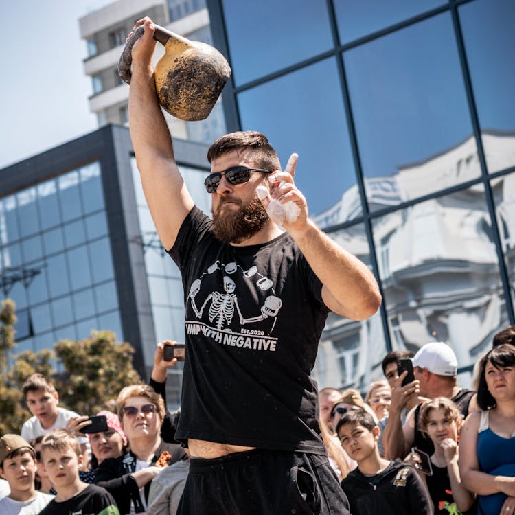 A Bearded Man Lifting A Kettle Bell