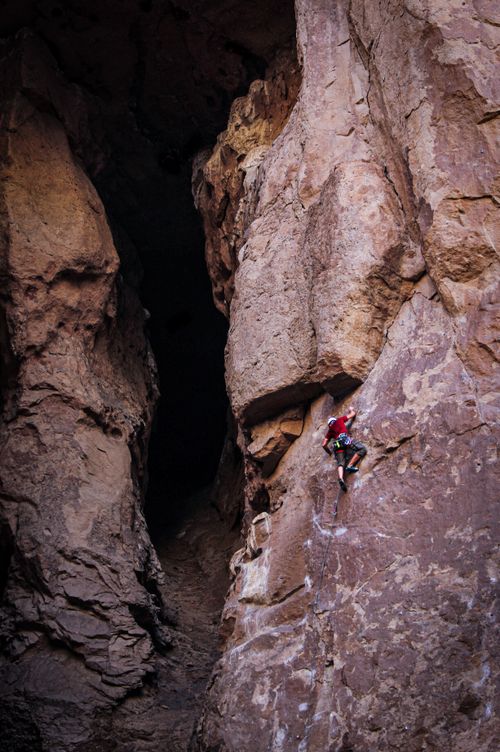 Free Daring rock climber ascending a steep cliff face in Gualjaina, Argentina. Adventure awaits. Stock Photo