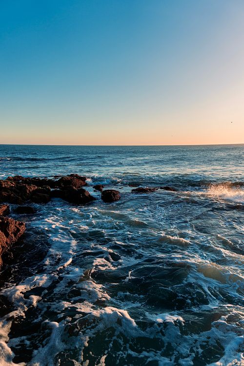 Free Scenic sunset over rocky Punta del Este coastline, Uruguay. Perfect for travel and nature themes. Stock Photo