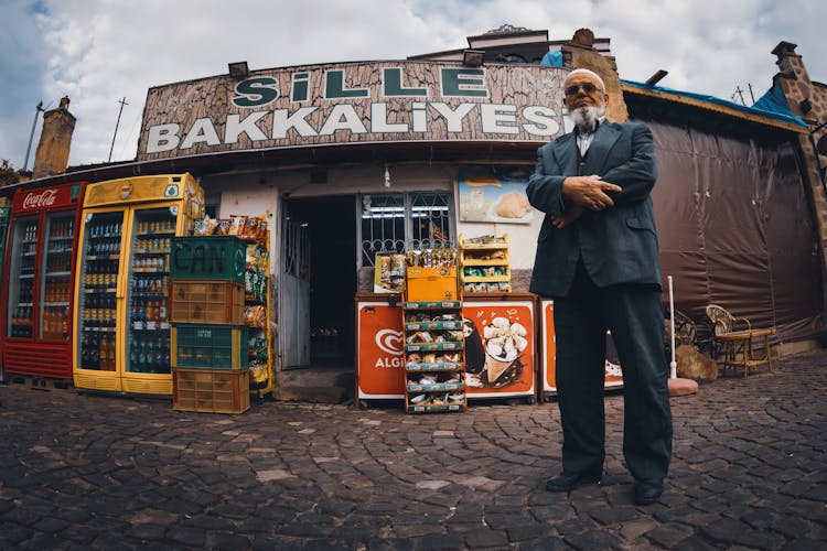 Man Standing In Front Of A Store