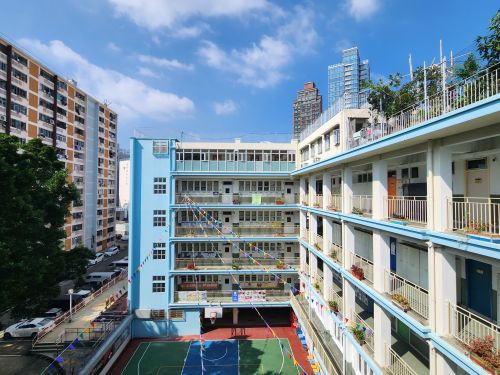 Free Colorful residential buildings in Kowloon, Hong Kong, showcasing urban architecture under a sunny blue sky. Stock Photo