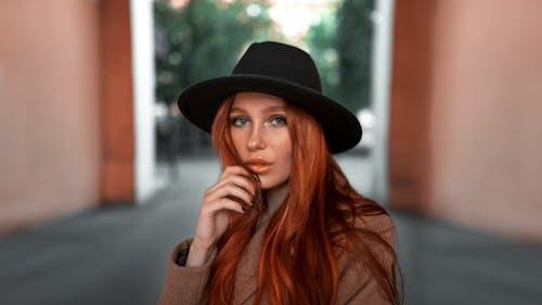 A Woman in Black Hat Looking with a Serious Face