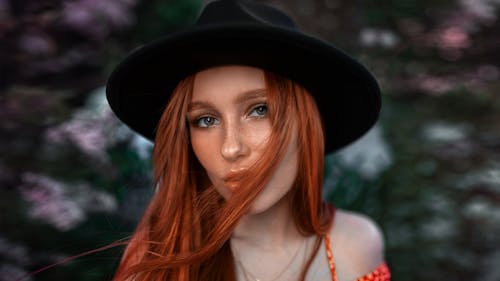 Pretty Woman Wearing a Black Hat Staring