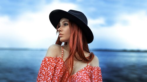 Woman in Floral Blouse Looking Afar