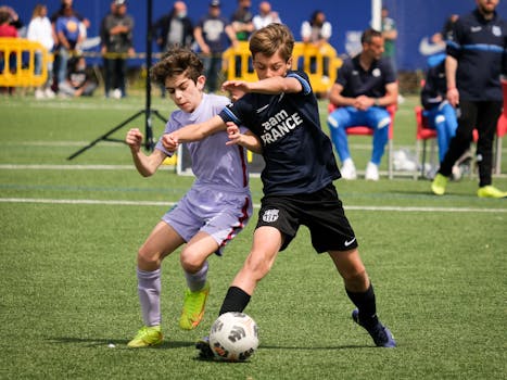 Young athletes compete in a lively soccer match in Barcellona, Italy, showcasing teamwork and sportsmanship.