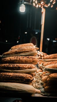 Charcoal grilled corn on display at a night street food stall in Istanbul, Turkey.