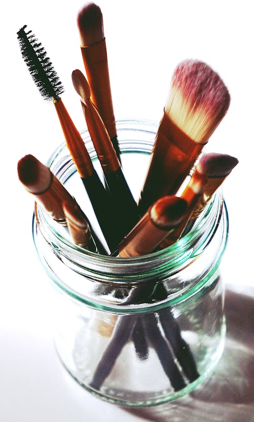 Free Brown Makeup Brushes in Clear Glass Mason Jar Stock Photo