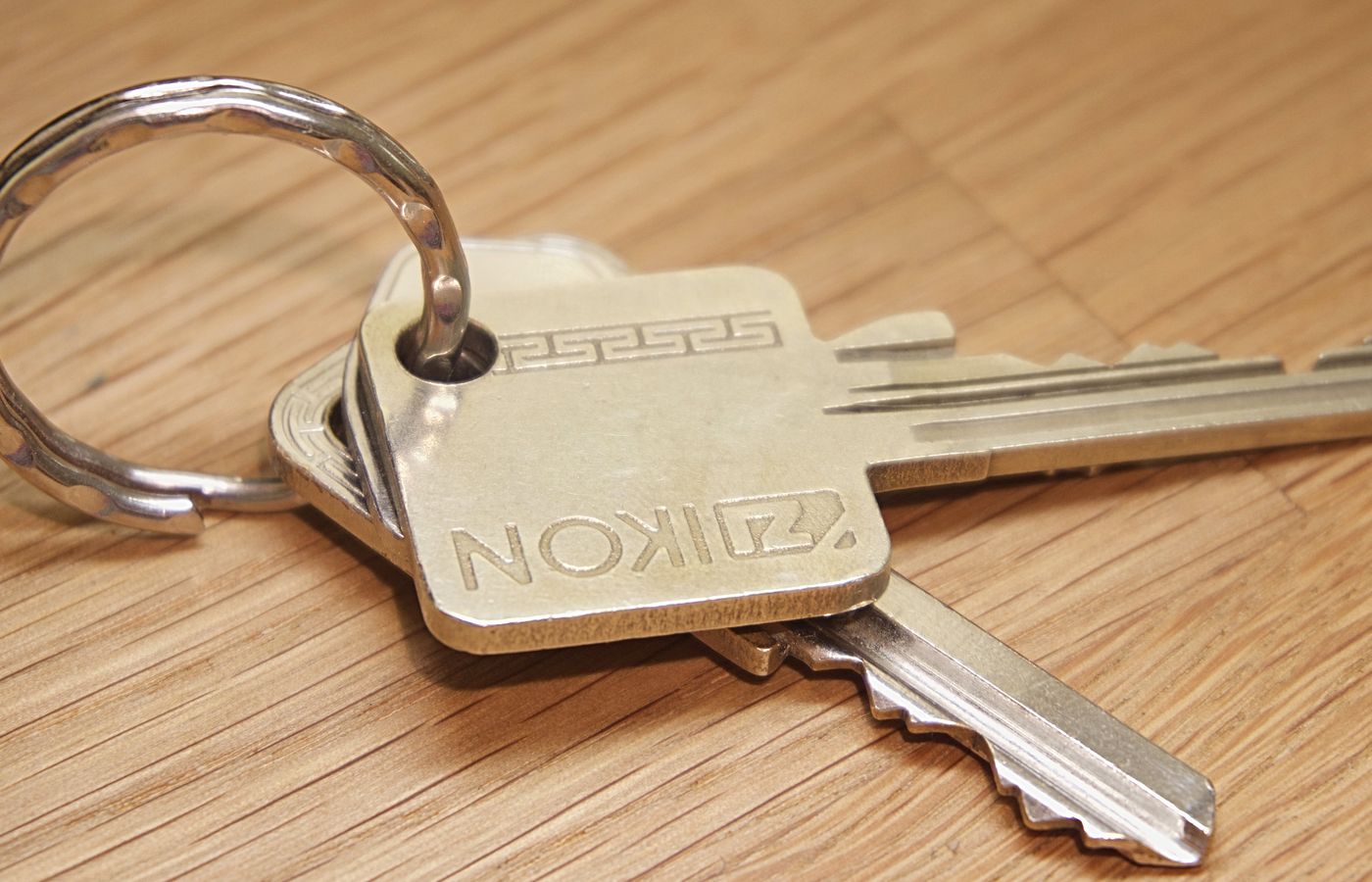 A set of metal house keys on a wooden surface, ideal for real estate themes.