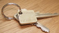 Gray Ikon Keys on Brown Wooden Surface