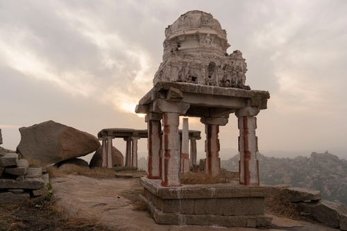 Free Sunrise over ancient ruins in Hampi, showcasing historic architecture amidst rocky landscapes. Stock Photo