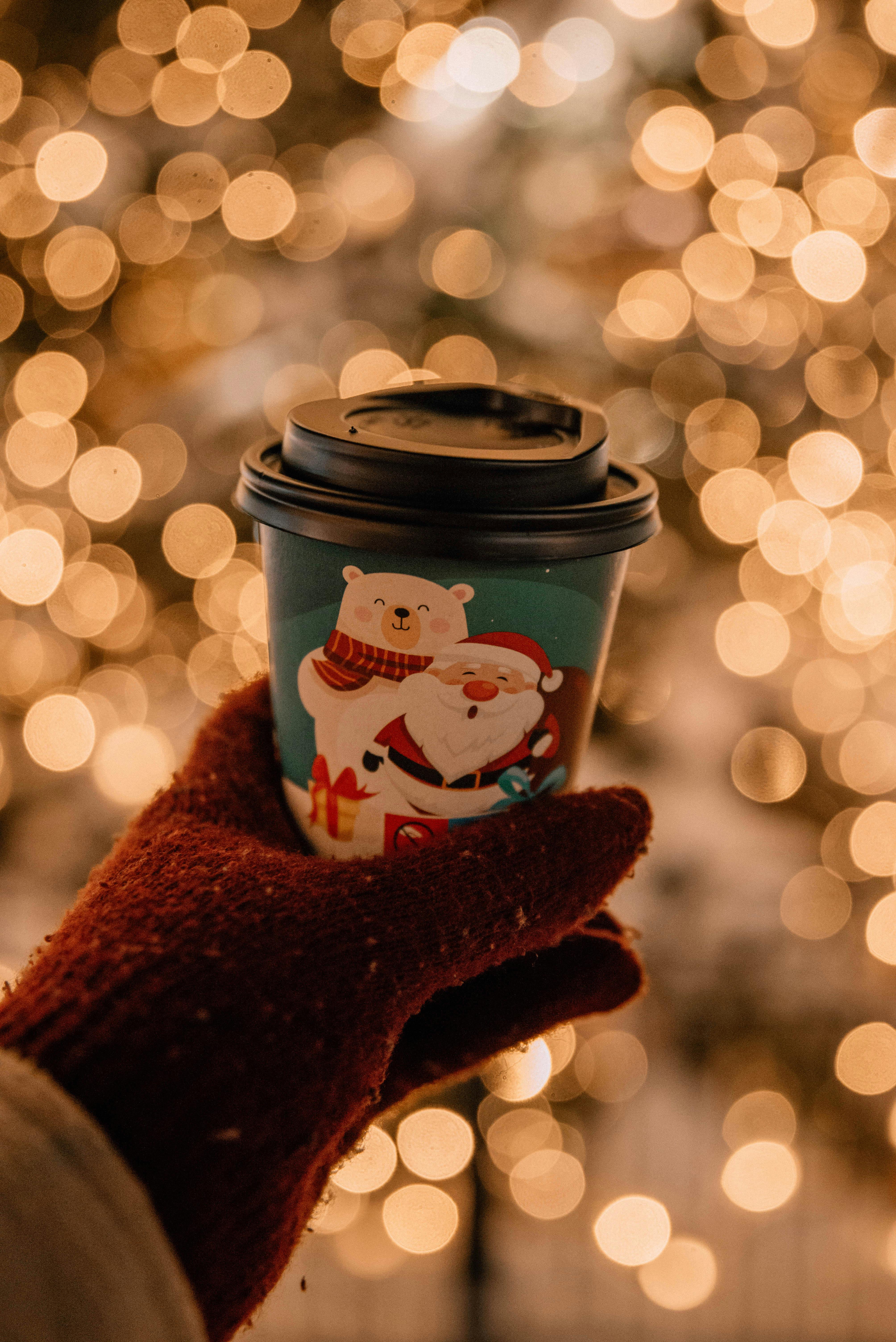 A cozy winter evening in Tallinn with a festive disposable cup and bokeh lights.