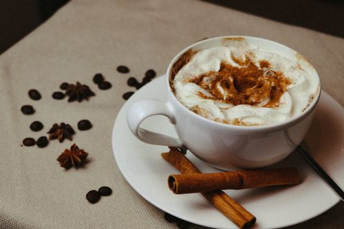 Free Warm and inviting cappuccino topped with cream and cinnamon, perfect for comfort and taste. Stock Photo
