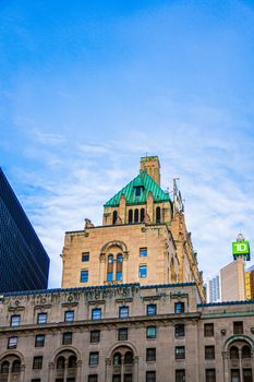 Low angle view of the historic Royal York Hotel in Toronto with a clear blue sky.