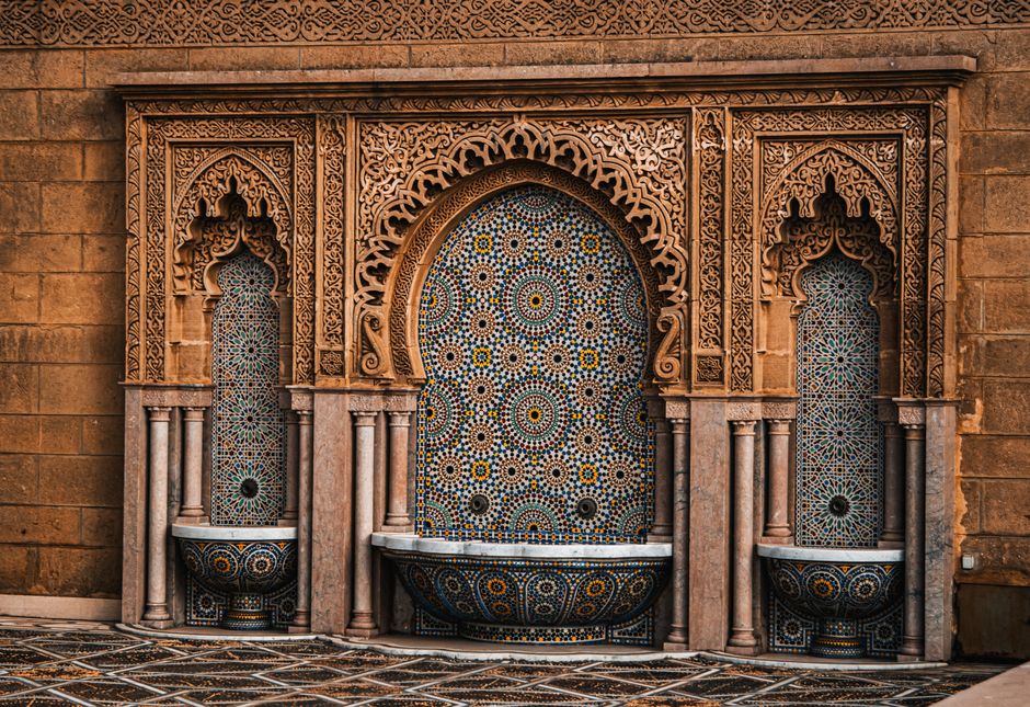 Detailed view of a beautifully designed Moroccan mosaic fountain wall with intricate patterns.