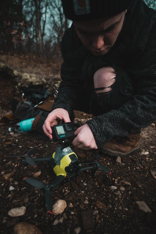 Young Man Setting up a Drone Camera 