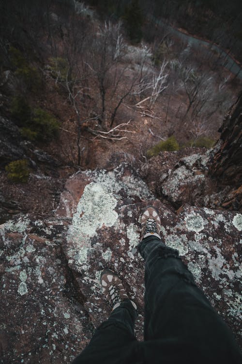 First Person Perspective of a Man Standing on a Cliff