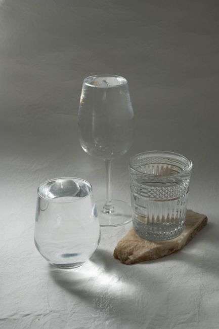 Elegant arrangement of various glasses filled with water, showcasing minimalist aesthetics.