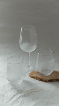 Artistic arrangement of frosted glassware on a textured surface; minimalist home decor style.