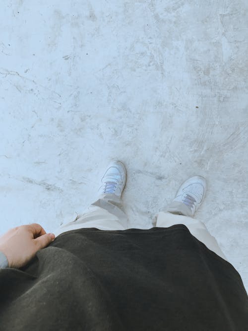 Person Wearing White Sneakers on White Floor