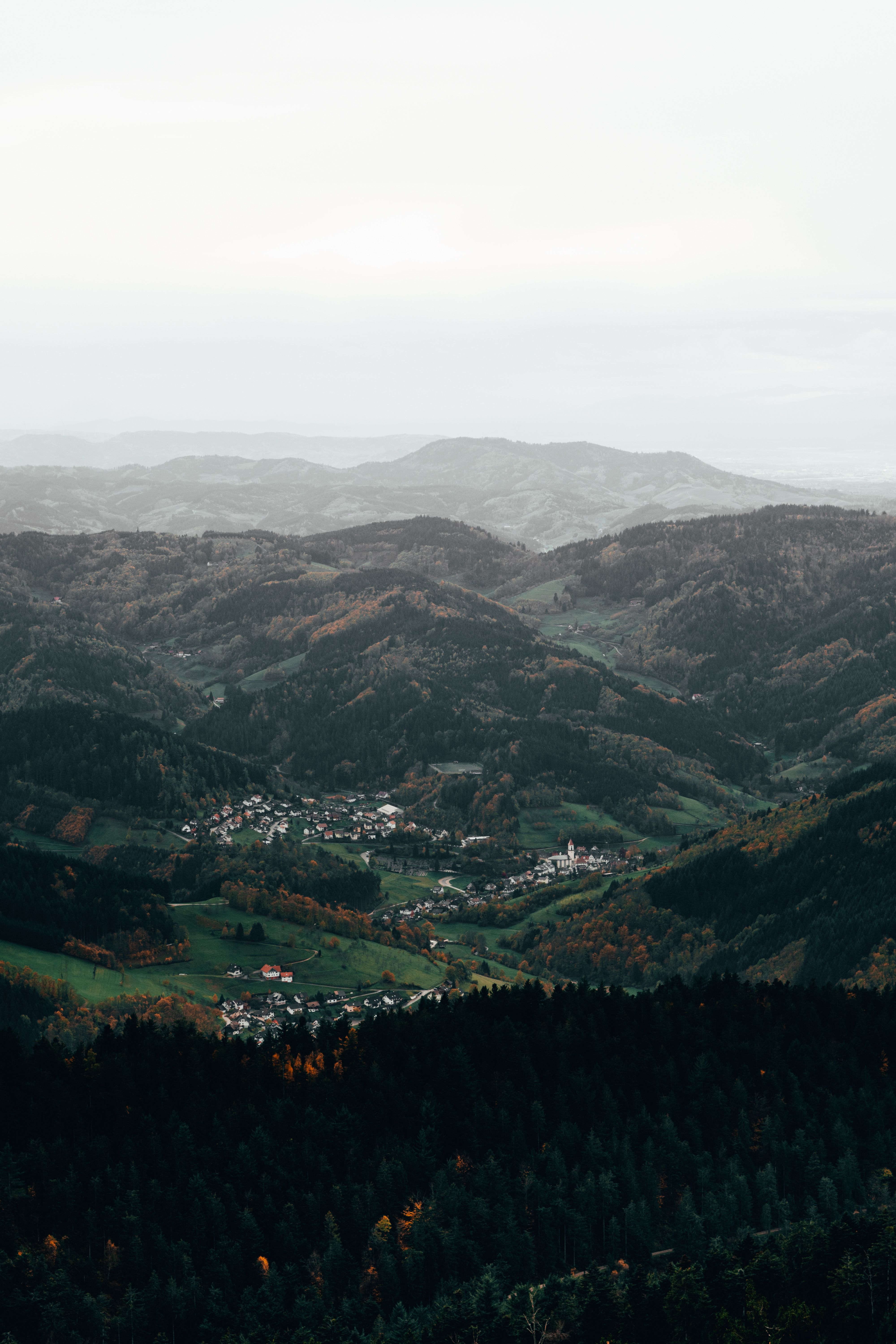 Aerial View of Mountains and a Village in a Valley · Free Stock Photo