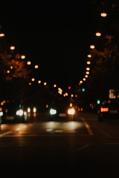 Free Blurred car lights on a Karlsruhe street at night create a dreamy urban scene. Stock Photo