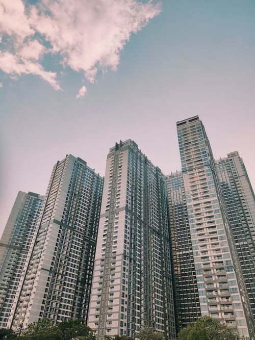 Free Low angle view of modern skyscrapers with a clear sky, ideal for urban architecture concepts. Stock Photo