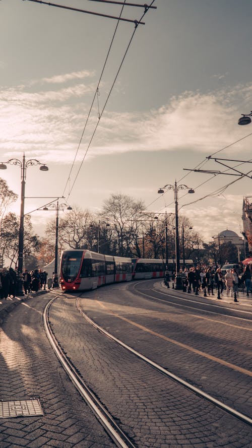 People Walking on the Street Near the Tram on the Road