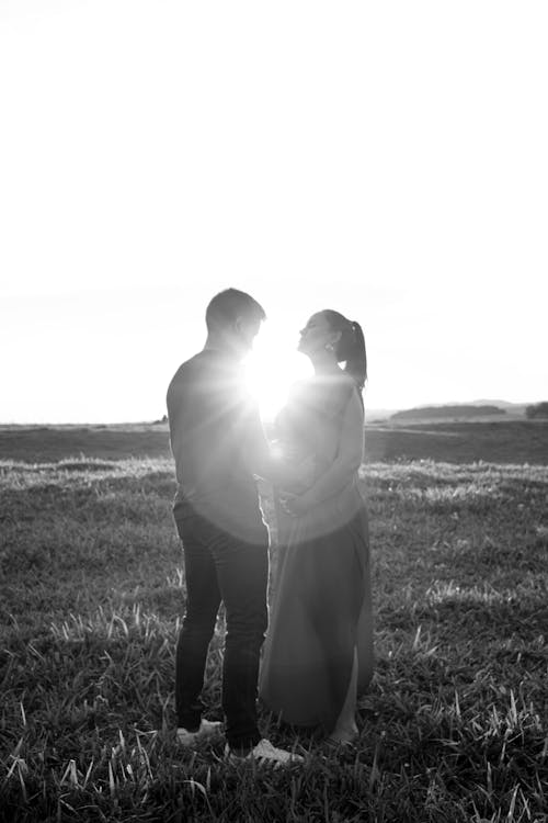 Man and Pregnant Woman in Sunlight
