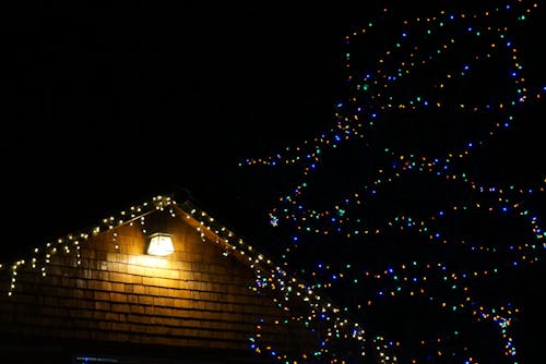 Free String Lights Hanging from House Roof Stock Photo