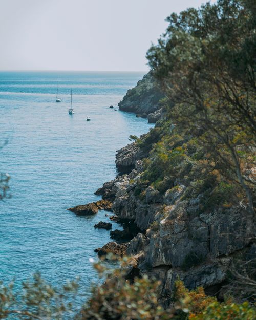 Free Beautiful view of cliffs and sailboats on a sunny day at Atlantic Ocean coastline. Stock Photo