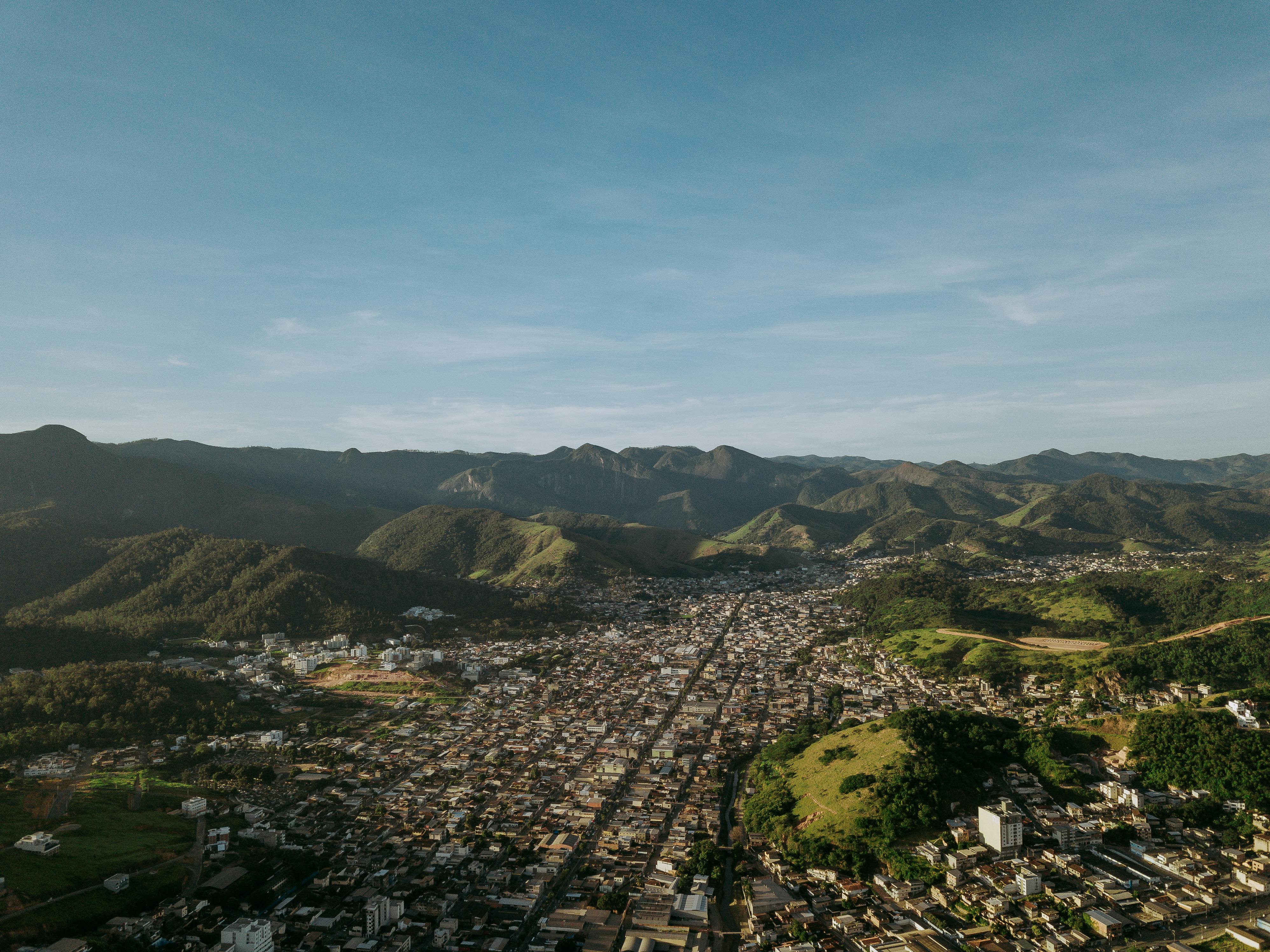 Breathtaking aerial cityscape of Coronel Fabriciano, MG, with mountain backdrop.
