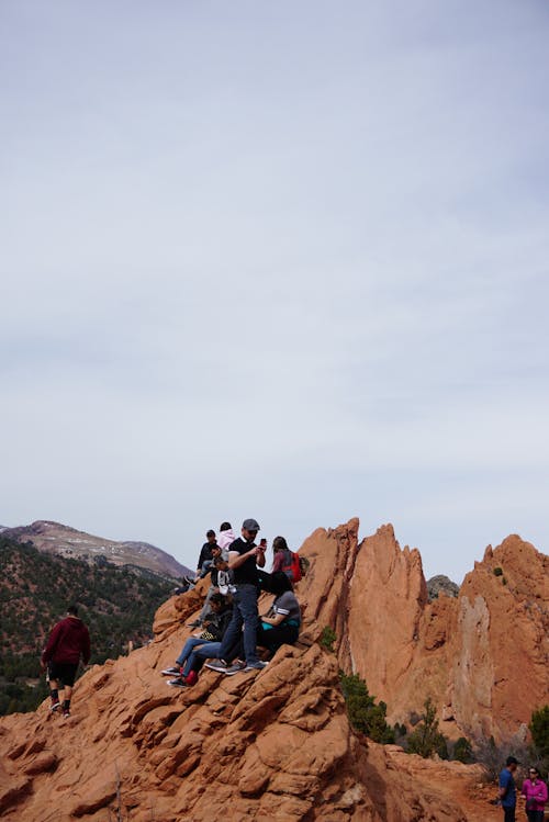 Free People on Brown Rock Formation Stock Photo