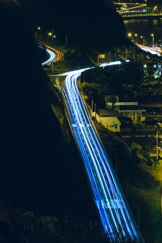 Discover the vibrant nightlife of Lima with this aerial view showcasing brightly lit streets and stunning urban architecture.