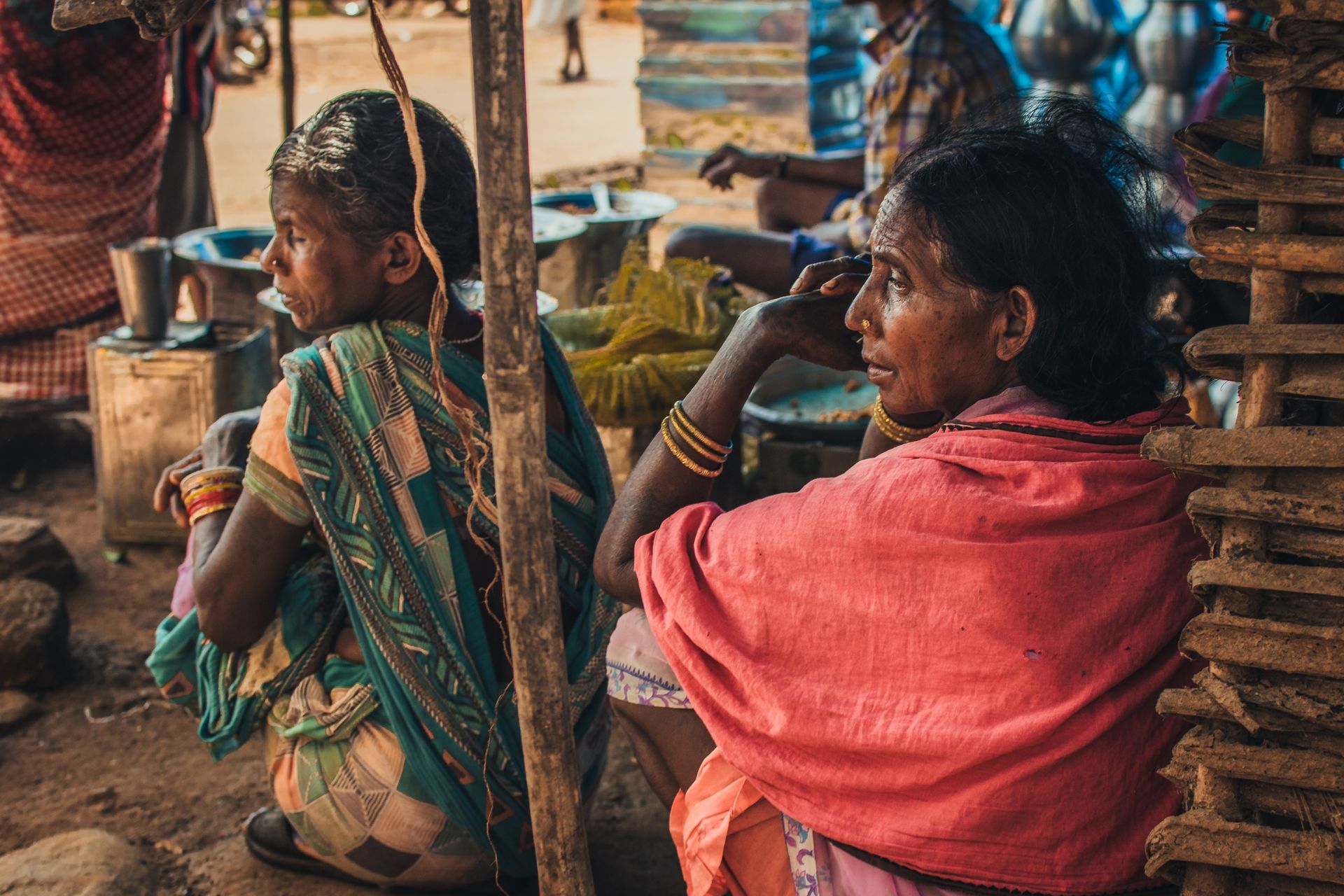 Wide view of a rural Indian village market under overcast skies