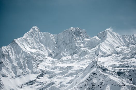 Majestic snow-covered mountain peaks under a clear blue sky, perfect winter landscape