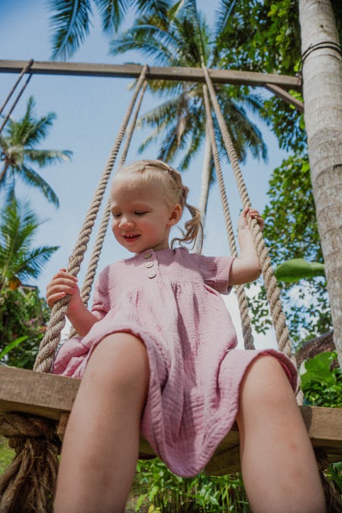A Young Girl Sitting on the Swing
