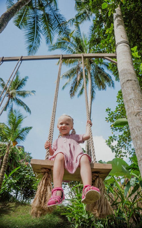 Low Angle Shot of a Girl on a Swing 