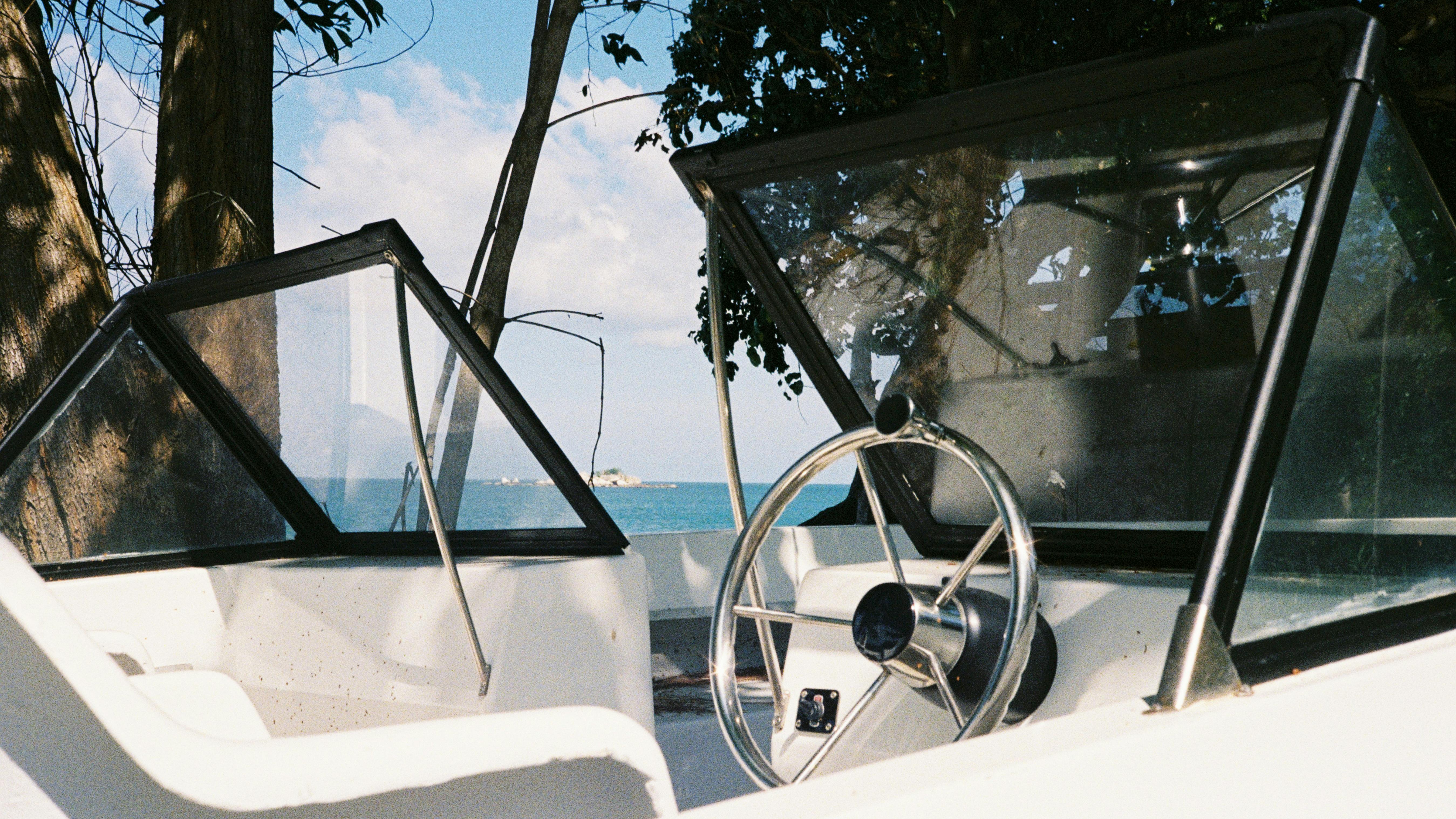 Serene view from a boat cockpit with the sea in the background on a sunny day.