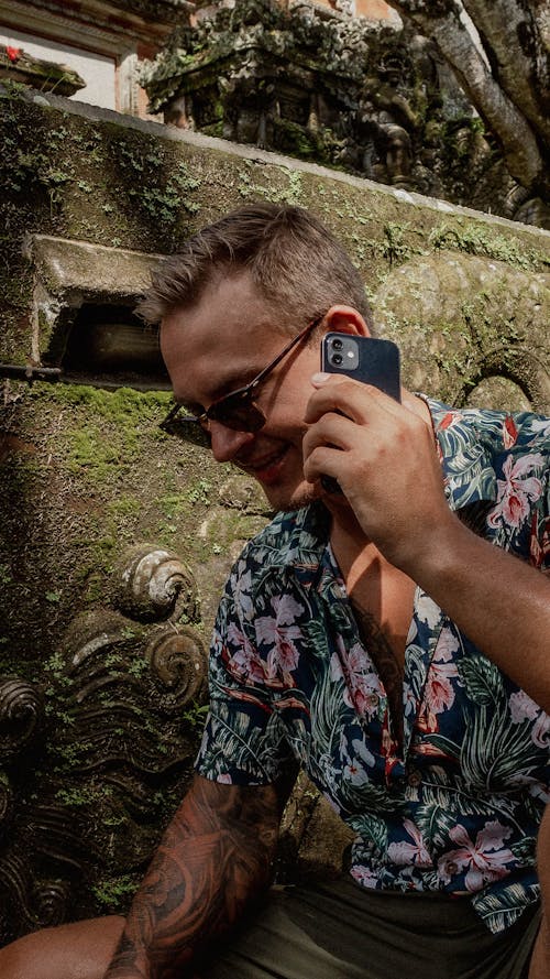 A Man in Floral Polo Talking on the Phone