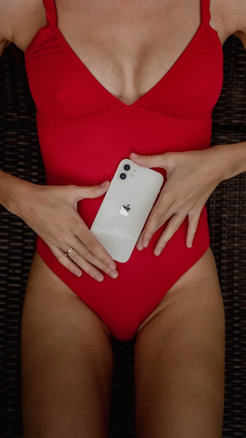 Woman in Red Swimsuit Holding a Cellphone