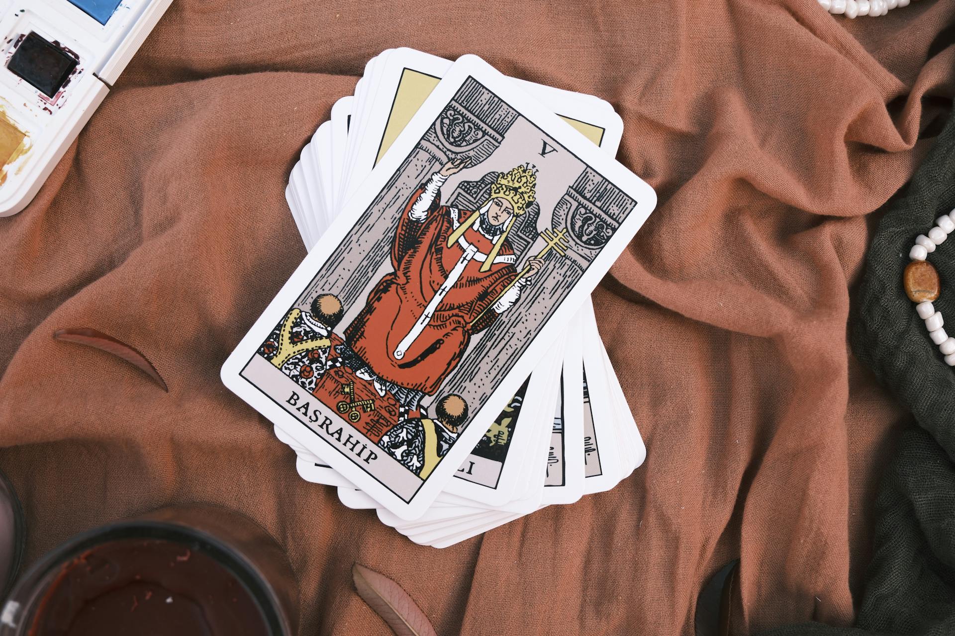 Deck of Tarot Cards on Brown Fabric