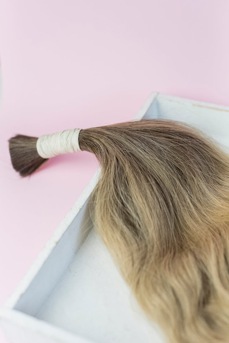 Bundle Of Hair Extension On Pink Background