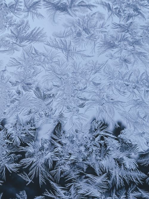 Free Close-up of frosty ice formations on a window, showcasing intricate natural patterns. Stock Photo