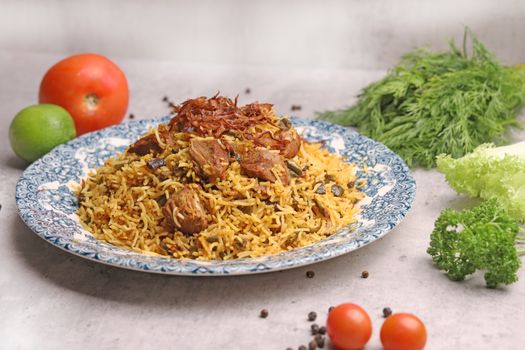 A beautifully plated lamb biryani dish with fresh herbs and vegetables, ideal for gourmet food lovers.