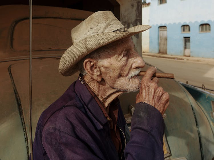 Old Man In Hat Smoking Cigar