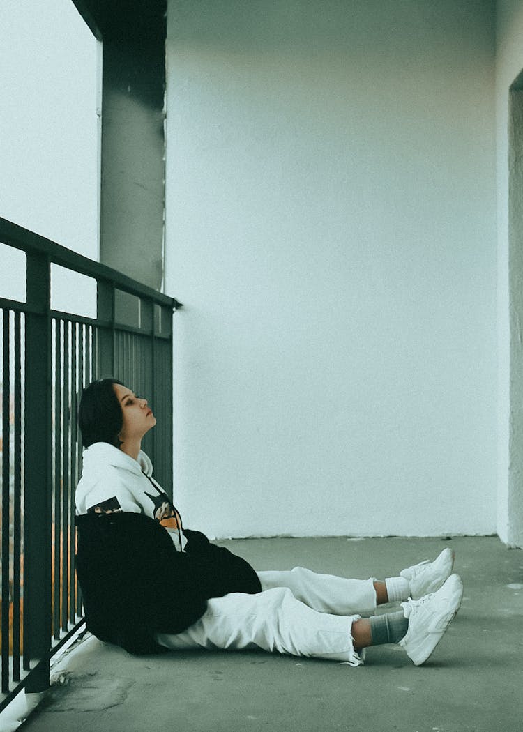 Woman Sitting On Balcony