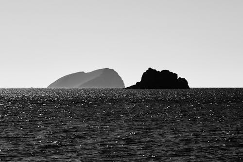Silhouette of Rock Formation in the Middle of the Ocean