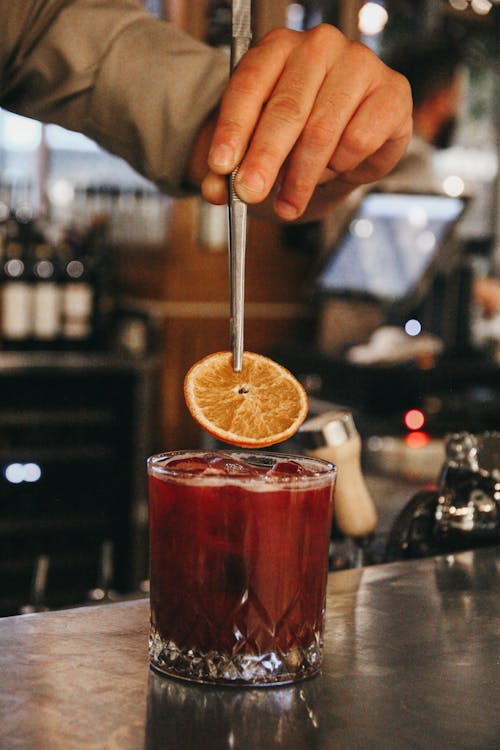 Drink with Ice Cubes and Slice of Lemon