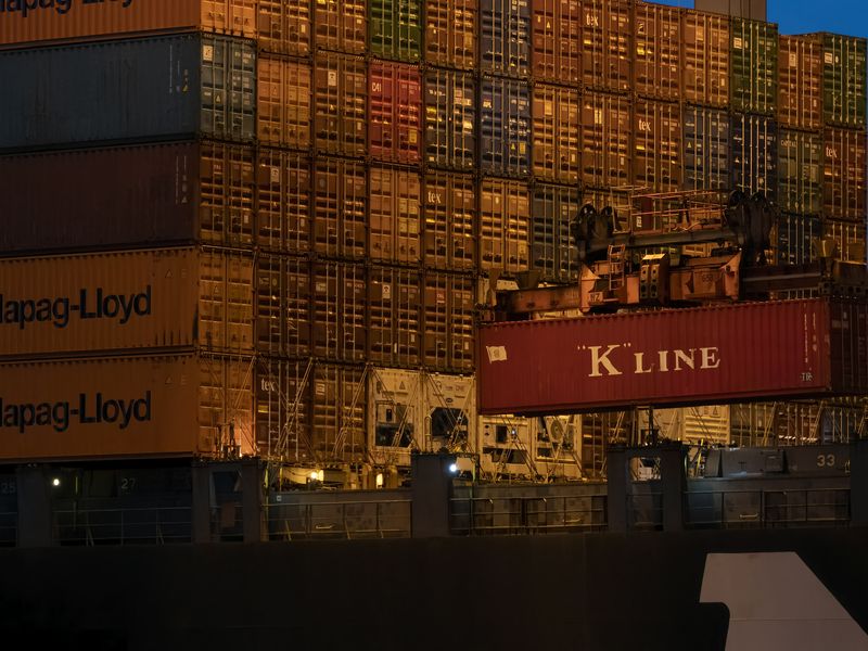logistics team reviewing shipping documents at a warehouse operations desk